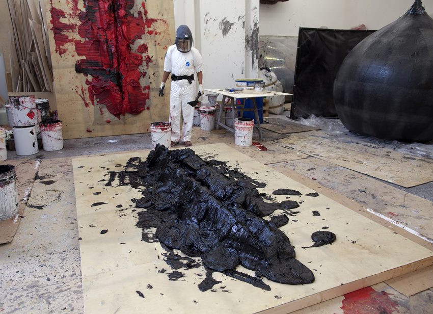 Artist Anish Kapoor making two new works in his Studio. One is on the wall behind him and the other on the floor in front of him