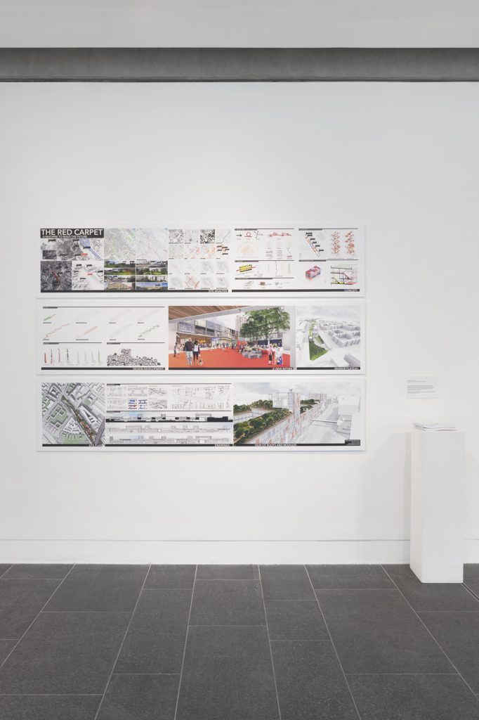 A series of maps, architectural plans and renders on a white wall. A large title reads THE RED CARPET.
