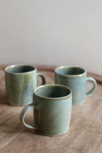 Green ceramic mugs.